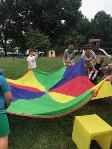 Children using parachute to play games
