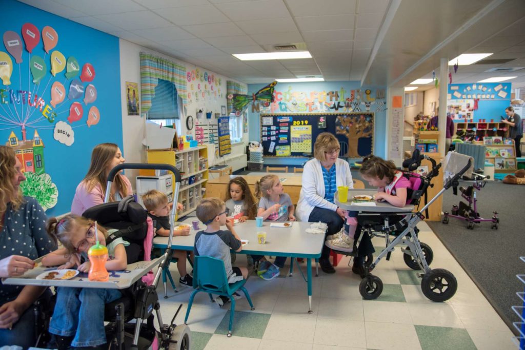 Children and instructors in a preschool classroom
